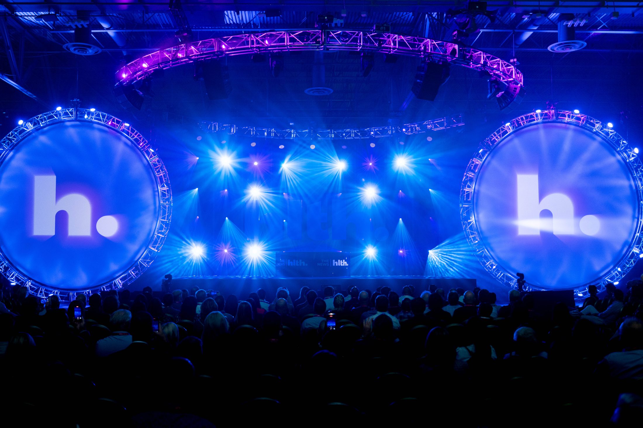 The HLTH main stage in full light with the audience seated, moments before the keynote