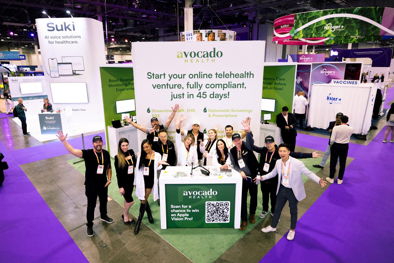 Booth team celebrating on the HLTH show floor