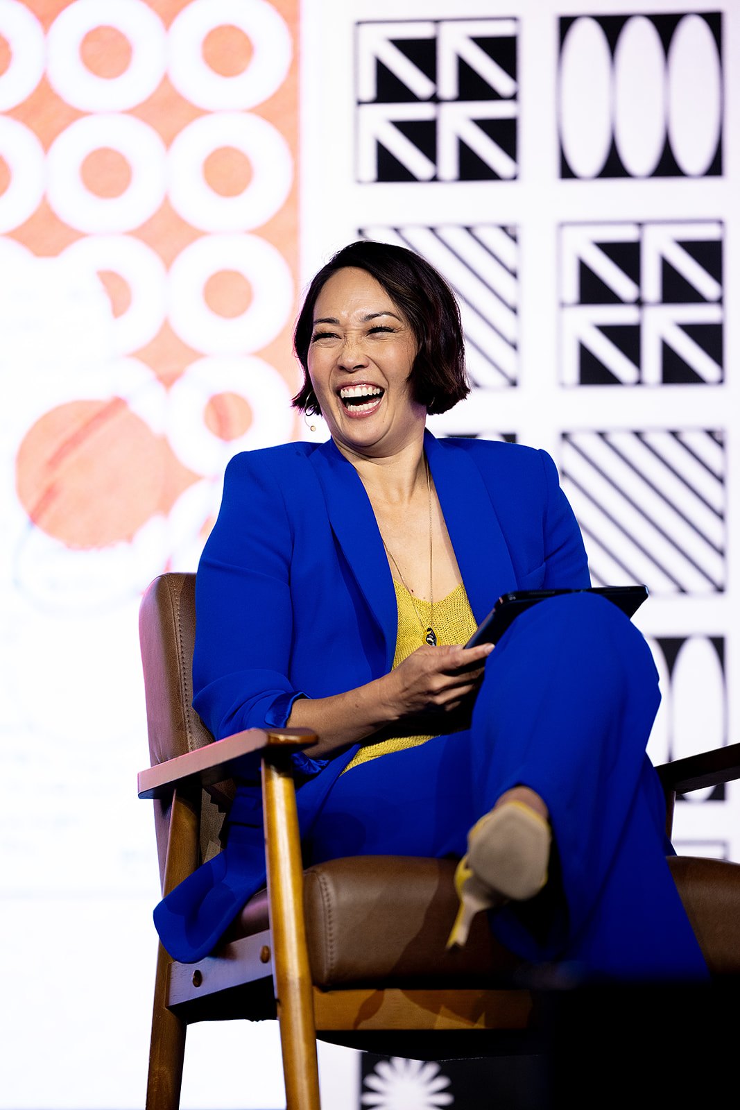 Speaker laughing on the Convening Leaders mainstage