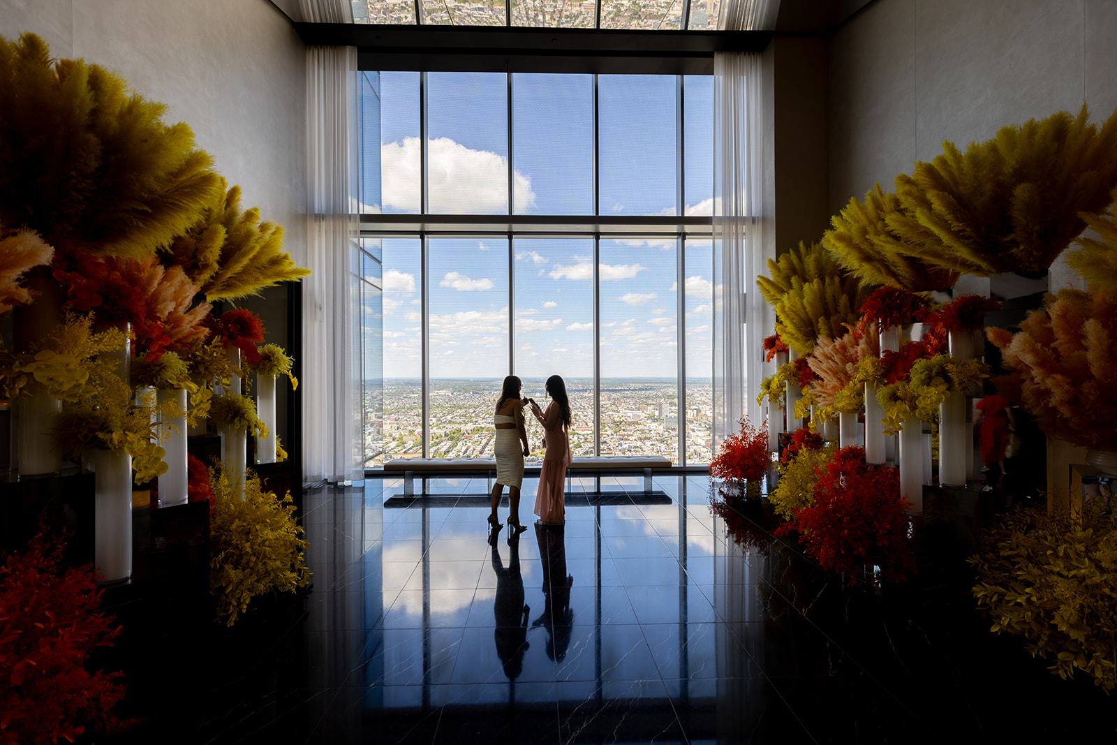 Guests taking in the skyline at the rooftop reception