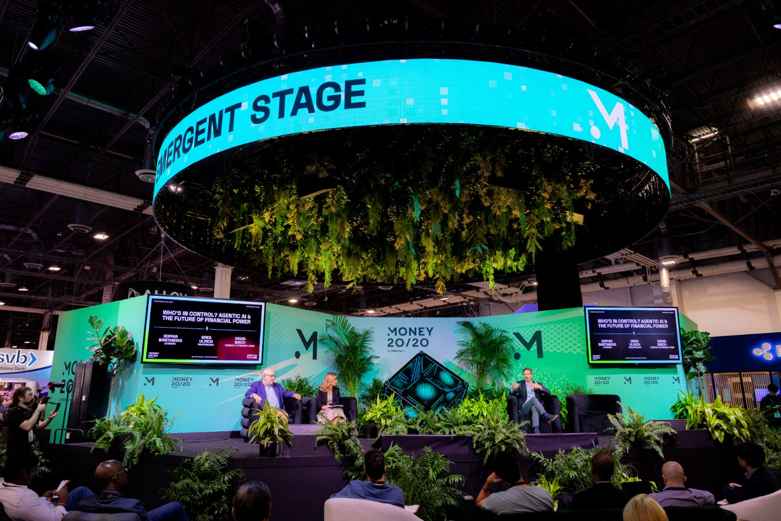 The Emergent Stage encased in hanging plants under a turquoise LED ring at Money20/20 USA 2025