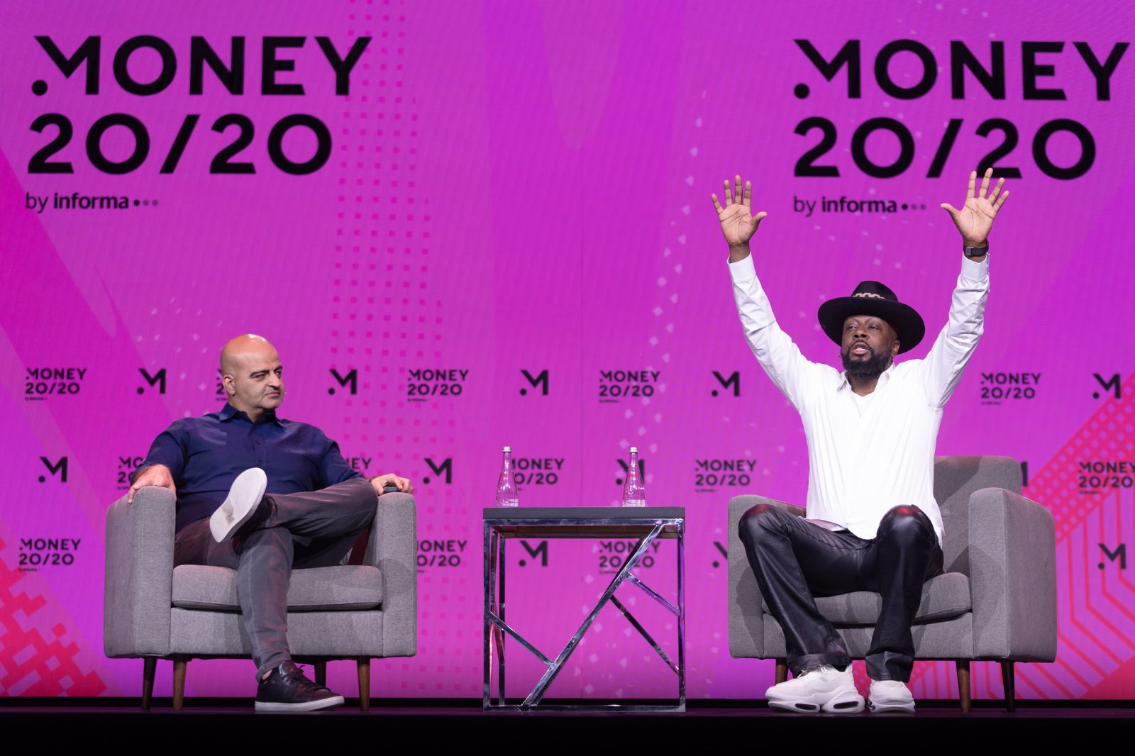 Money Pot speaker on stage with the giant honey-pot graphic