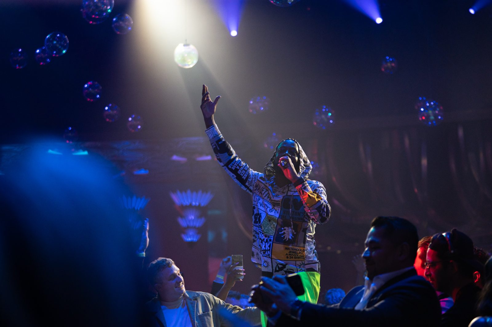 Money Awards rooftop trophy moment with green stage lighting