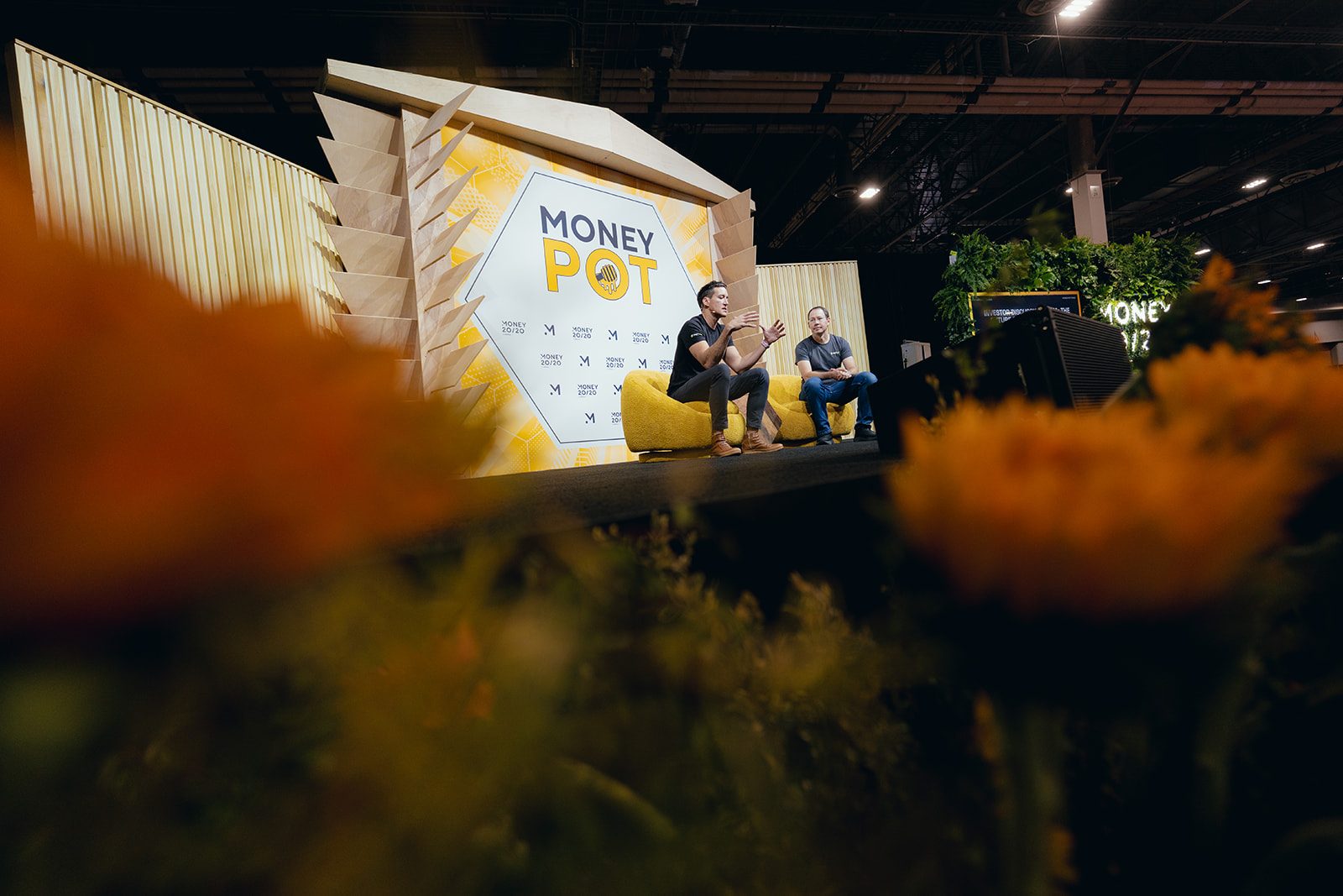 Smiling attendees in a floral M-letter photo moment