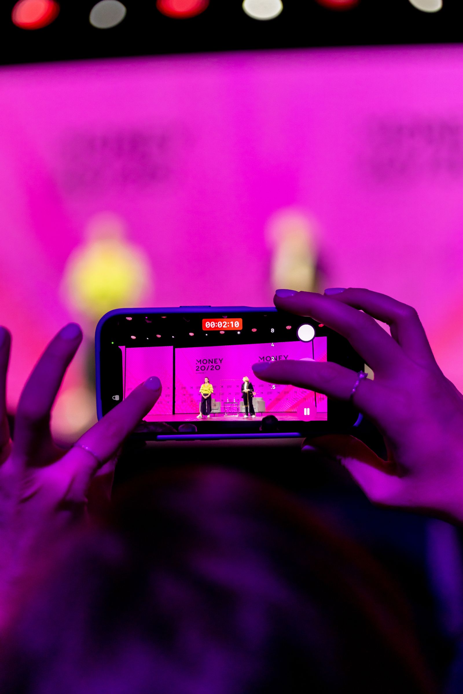An attendee filming the Money20/20 mainstage on a phone